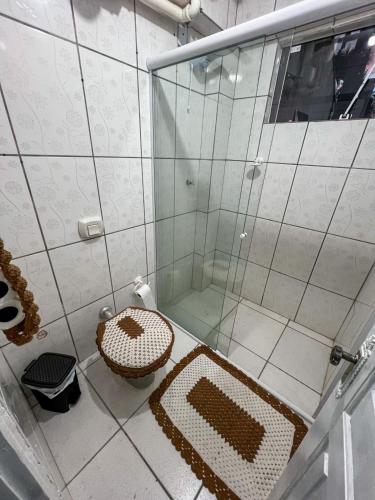 a bathroom with a shower with a toilet and a sink at Hospedagem Doce lar in Joinville