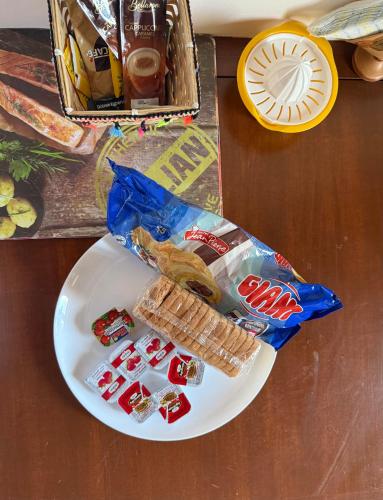 a white plate with some food on a table at The Twin Houses in Metamórfosis