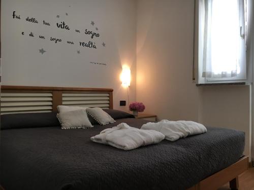 a bed with two white pillows on top of it at Trento Life in Trento