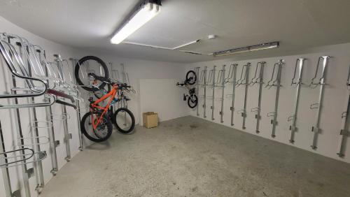 a garage with bikes hanging on the wall at Appart 4 pers pied des pistes- l'Ecrin-les BERGERS- Chez Lexy in L'Alpe-d'Huez