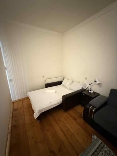 a small room with a bed and a couch at Apartment for Daily Rent in the Heart of Tbilisi in Tbilisi City