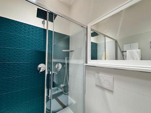 a bathroom with a glass shower and a mirror at Le suite del Duomo - 2 in Cava deʼ Tirreni