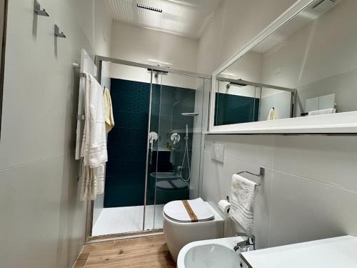 a bathroom with a shower and a toilet and a sink at Le suite del Duomo - 2 in Cava deʼ Tirreni