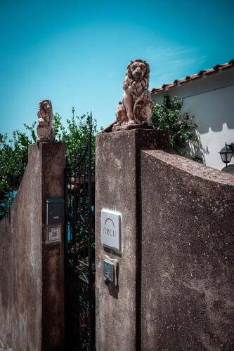 a gate with two lion statues on top of it at Arcu Retreat in Positano