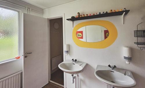 a bathroom with a sink and a mirror at Orrefors Vandrarhem in Nybro