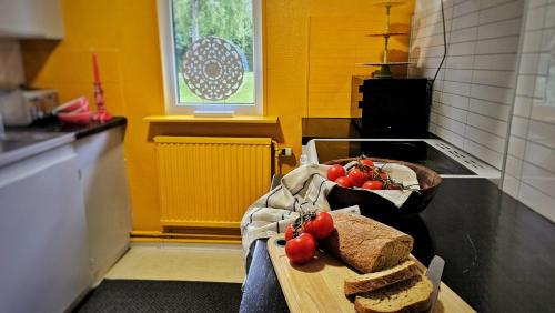 a kitchen with bread and tomatoes on a cutting board at Orrefors Vandrarhem in Nybro