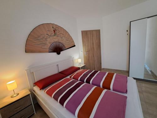 a bedroom with a bed and a mirror on the wall at Mirtusz apartment in Balatonfenyves