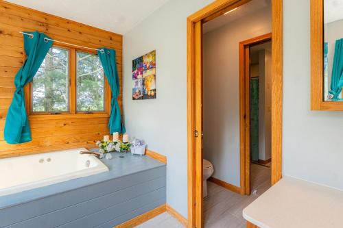 a bathroom with a tub and a sink at Panorama Point - Gorgeous views, hot tub, theater in Davis