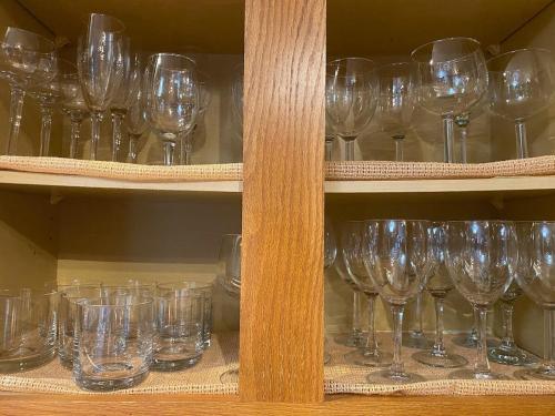a bunch of wine glasses on a shelf at Panorama Point - Gorgeous views, hot tub, theater in Davis