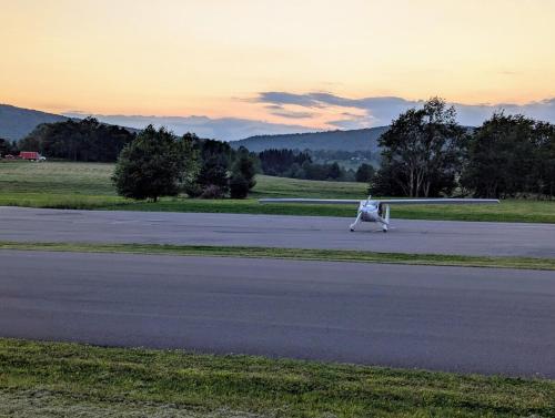 a small airplane on a runway with a sunset in the background at Panorama Point - Gorgeous views, hot tub, theater in Davis