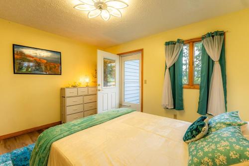 a yellow bedroom with a bed and a window at Panorama Point - Gorgeous views, hot tub, theater in Davis