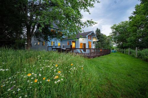 a house in the middle of a field of grass at Panorama Point - Gorgeous views, hot tub, theater in Davis
