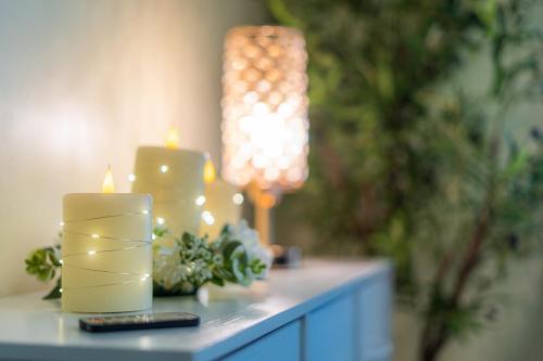 a table with two candles and a remote control at Panorama Point - Gorgeous views, hot tub, theater in Davis