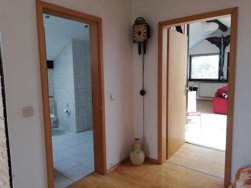 a room with a bathroom with a shower and a mirror at Großzügige und kunstvolle Dachgeschosswohnung in Leichlingen