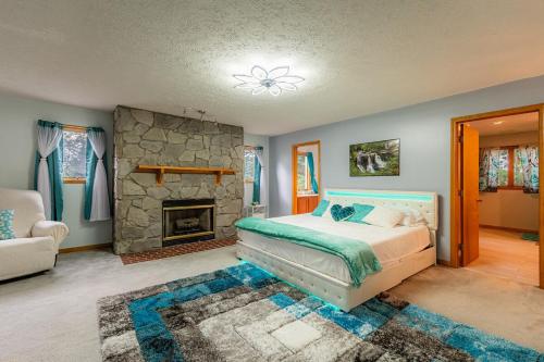 a bedroom with a bed and a fireplace at Panorama Point - Gorgeous views, hot tub, theater in Davis