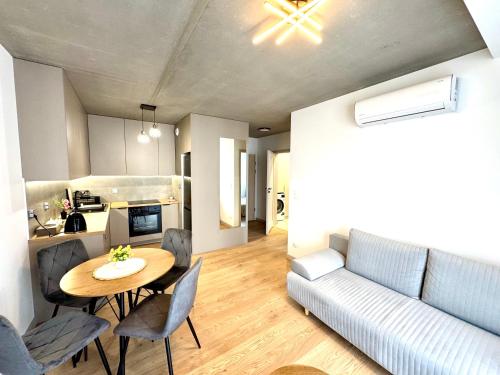 クラクフにあるApartament Piastów - PARKINGのテーブルとソファのあるリビングルーム