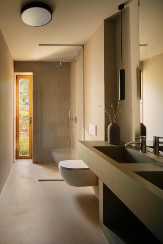 a bathroom with two sinks and a toilet at Nine Olives Hvar in Stari Grad