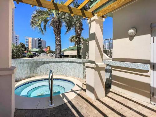 a hot tub on the side of a building with palm trees at Silver Shells in Destin