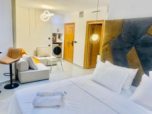 a bedroom with a bed and a living room at nouvelle studio climatisé in Fès