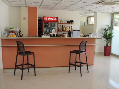 a restaurant with two chairs sitting at a counter at Sitia Bay in Sitia