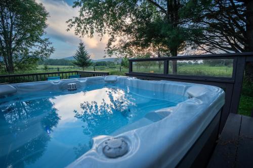 a jacuzzi tub with a view of a field at Panorama Point - Gorgeous views, hot tub, theater in Davis