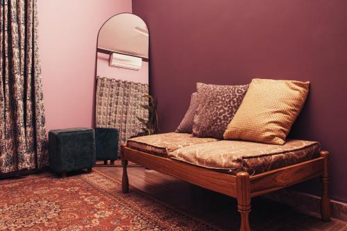 a couch in a room with a mirror and a mirror at The Mountain Retreat, Muzaffarabad - Families Only in Muzaffarabad