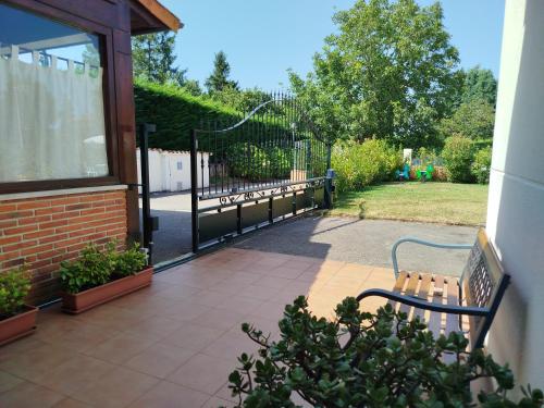 a bench sitting outside of a house with a fence at Cabárceno Chalet vacacional Casa Pedro La Abadilla in La Abadilla