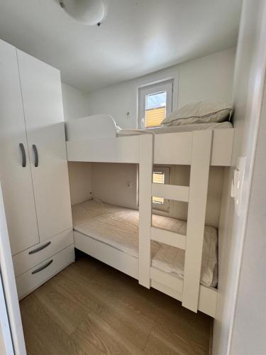 a small room with a bunk bed and a window at Luxury Houseboat Lavender in Portorož