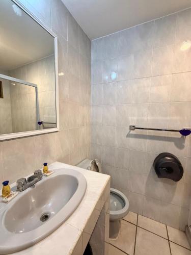 a bathroom with a sink and a toilet at Departamento Cielo in Puerto Vallarta
