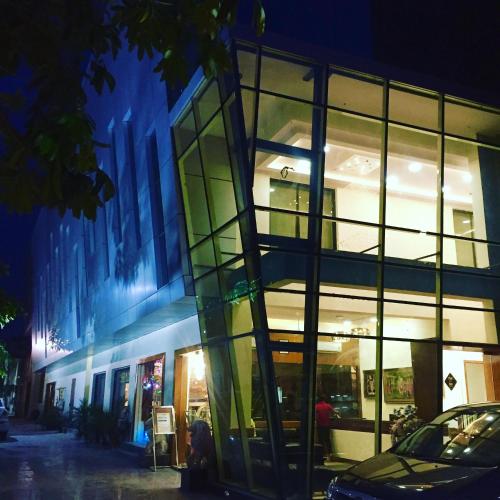 a glass building with a car parked in front of it at Hotel Kridha Residency - Opposite Prem Mandir Vrindavan in Mathura