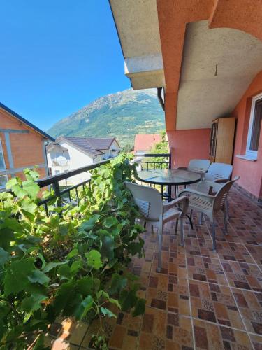 a patio with a table and chairs and plants at Dino's Apartments in Plav