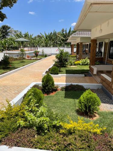 a garden in front of a building at Kels Place ,Runda , Chogoria , Tharaka Nithi, Kenya in Mwangarimwe