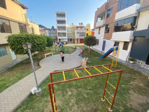 a park with a playground with a slide at Monoambiente céntrico in Trujillo