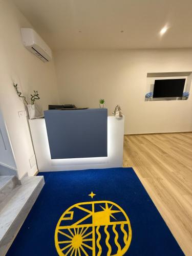 a room with a blue rug on the floor at Dimora Luminè in Naples