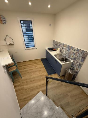 a kitchen with a sink and a counter at Dimora Luminè in Naples
