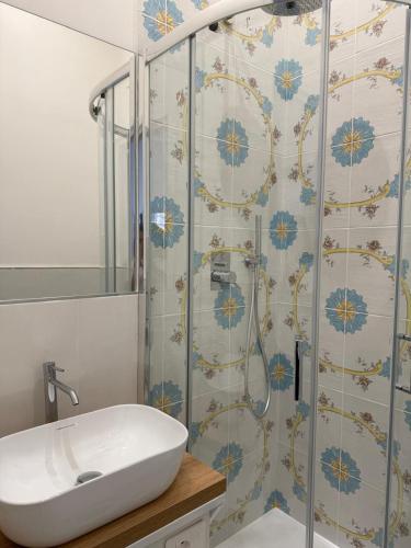 a bathroom with a sink and a shower at Dimora Luminè in Naples