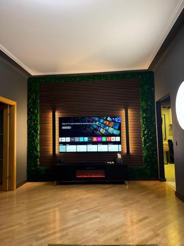 a living room with a large flat screen tv at Downtown Kaunas - Maironis 10 in Kaunas