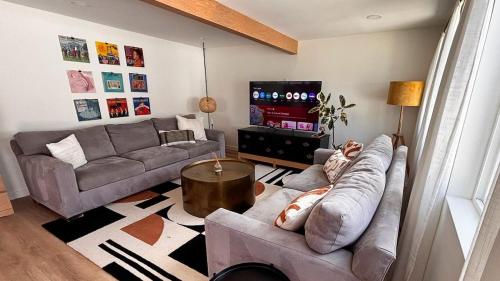 a living room with a couch and a tv at San Diego Oasis Fire Pit, Putting Green, Near Everything in San Diego