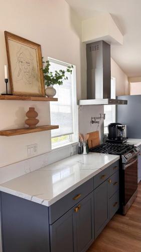 a kitchen with a stove and a counter top at San Diego Oasis Fire Pit, Putting Green, Near Everything in San Diego