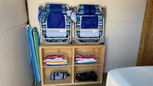a small closet with folded towels and umbrellas at San Diego Oasis Fire Pit, Putting Green, Near Everything in San Diego
