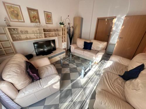 a living room with two couches and a fireplace at Ferienwohnung Warnemünde in Rostock