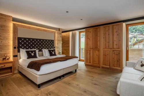 Ένα ή περισσότερα κρεβάτια σε δωμάτιο στο Boutique Hotel e Chalets Salvadori