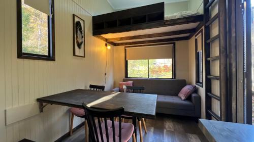 a living room with a table and a couch at Cabañas Alto Bosque in Pucón