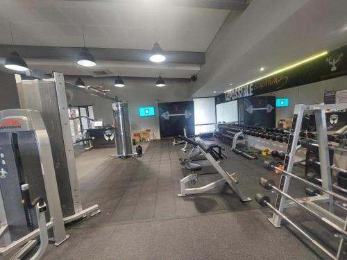 a gym with rows of treadms and machines at 13 Sunningdale - Jackals Creek Golf Estate in Roodepoort