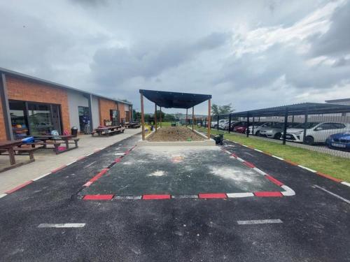 a parking lot with a blue canopy in front of a building at 13 Sunningdale - Jackals Creek Golf Estate in Roodepoort