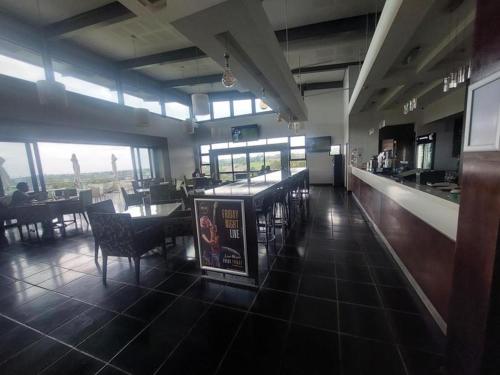 a dining room with tables and chairs in a restaurant at 13 Sunningdale - Jackals Creek Golf Estate in Roodepoort