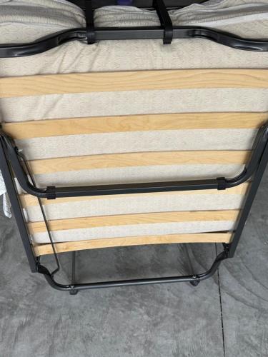 a bed frame with wooden boards on top of it at Abi home in Brandon