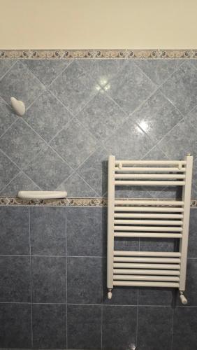 a bench sitting on a tiled floor in a bathroom at Cumbres Nevadas - Hostería Boutique in El Chalten