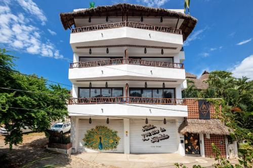 a building with a balcony on top of it at Makawe in Sayulita