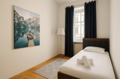a bedroom with a bed and a painting on the wall at Salzburg Apartments in Salzburg